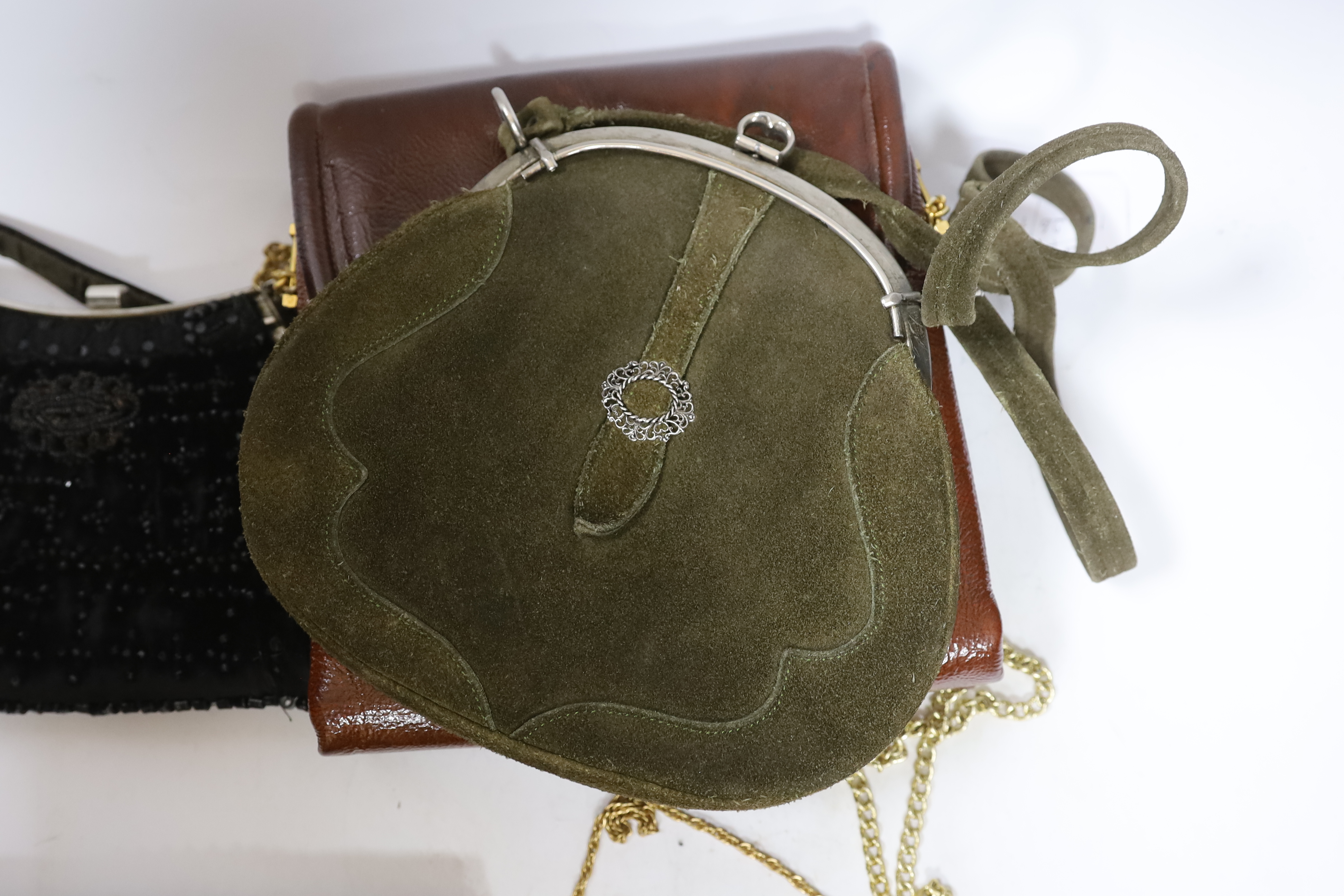 A Tseklenis ladies handbag, a green suede bag, five various evening bags and two purses